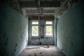 Old abandoned room with two windows at the building at the Chernobyl ghost town