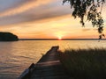 Old abandoned and ruined pier overgrown with reeds on the seashore at sunset Royalty Free Stock Photo