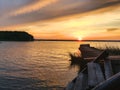 Old abandoned and ruined pier overgrown with reeds on the seashore at sunset Royalty Free Stock Photo