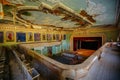 Old abandoned ruined stage theater with paingings