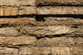 Old abandoned ruined yellow brown stone wall background texture