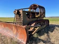 Old abandoned rusted tractor distant corner view Royalty Free Stock Photo