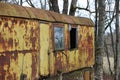 Old abandoned rusted vagon house property in a forest