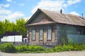 Old abandoned rustic wooden house with three windows on facade Royalty Free Stock Photo