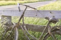 An old abandoned rusty bike parked against a wooden fence Royalty Free Stock Photo