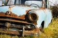 Old, abandoned rusty car wreck front and lamp. Royalty Free Stock Photo