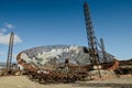 Old, abandoned and rusty parabola antenna with three towers