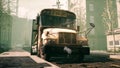 An Old Abandoned Rusty School Bus Stands In The Middle Of The Road In A Deserted City. The Image For Historical, Retro