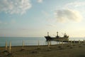 An old abandoned rusty ship near the shore. The ship ran aground.The ship is off the coast at sunset.