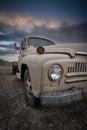 Old abandoned rusty truck with cloudy sky background Royalty Free Stock Photo