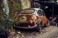 Old abandoned rusty white and orange vintage car