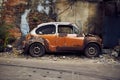 Old abandoned rusty white and orange vintage car