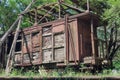 Old abandoned rusty wooden train and cargo wagon on the railway in the forest Royalty Free Stock Photo