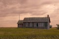 An old, abandoned school house sitting in the middle of the great plains Royalty Free Stock Photo