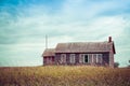 An old, abandoned school house sitting in the middle of the great plains Royalty Free Stock Photo
