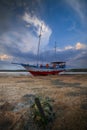 Old abandoned ship on the ocean shore. Broken ship. Sandy beach. Sunset view. Blue sky with white motion clouds. Vertical layout. Royalty Free Stock Photo