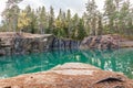 Old abandoned silver mine with blue, emerald water on a sunny evening. silverberg in Sweden. selective focus Royalty Free Stock Photo