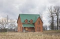 An old abandoned spooky house in spring on a farm yard in rural Canada