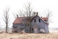 Old abandoned spooky looking farmhouse in winter on a farm yard in rural Canada Royalty Free Stock Photo