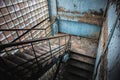 Abandoned staircase angle shot in damaged corridor