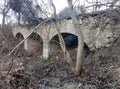 old abandoned stone bridge with arches in the forest Royalty Free Stock Photo