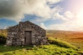 Old abandoned stone house without the roof. Sunset time. Rural Irish farm building. Dramatic sky. Old architecture example. Top Royalty Free Stock Photo