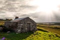 Old abandoned stone house without the roof. Sunset time. Rural Irish farm building. Dramatic sky. Old architecture example. Top Royalty Free Stock Photo