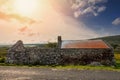 Old abandoned stone house without the roof. Sunset time. Rural Irish farm building. Dramatic sky. Old architecture example. Top Royalty Free Stock Photo