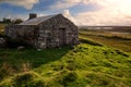 Old abandoned stone house without the roof. Sunset time. Rural Irish farm building. Dramatic sky. Old architecture example. Top Royalty Free Stock Photo