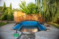 an old abandoned swimming pool with a metal bridge Royalty Free Stock Photo