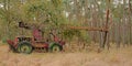 Old abandoned tractor with crane hidden in nature Royalty Free Stock Photo
