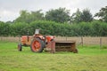 Old abandoned tractor with rusty hay turner in meadow Royalty Free Stock Photo