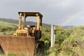 Old & Abandoned Tractor Standing In Field With Light Rainbow Coverage