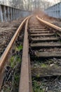 Old, dilapidated and abandoned railway station with rusty railway tracks and wooden railway sleepers Royalty Free Stock Photo