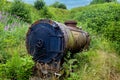 An old abandoned train tank car in the middle of the woods