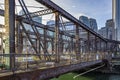 Old abandoned truss bridge in the bay on the modern waterfront in Boston