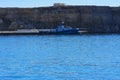 Old abandoned tugboat near the shore in the Red Sea against the blue sky of old coral reefs