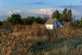 Old abandoned Ukrainian house in the fields on a cloudy day, rural landscape Royalty Free Stock Photo