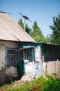 An old abandoned village house with a number 49 on a sign. A blue door entrance and an old antenna on a roof Royalty Free Stock Photo