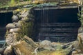 Old, abandoned water mill with water streams and little waterfalls