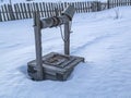 An old abandoned water well surrounded by snow. Royalty Free Stock Photo