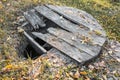 Old abandoned well with a broken wooden lid Royalty Free Stock Photo
