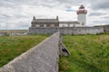 Old abandoned white light house. Cloudy sky