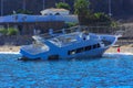 An old abandoned white sea yacht sank in the Red Sea against the blue sky of old coral reefs