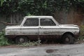 Old abandoned white Soviet car, brand Zaporozhets.