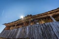 Old abandoned wooden balcony under blue sky