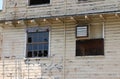 Old, abandoned wooden barracks, with smashed and boarded up windows, form a picture of blight. Royalty Free Stock Photo