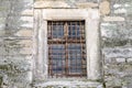 Old abandoned wooden box with glass of rusty metal bars in the concrete wall in a building of ancient architecture in Lviv Royalty Free Stock Photo