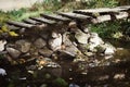 Old abandoned wooden bridge across stream Royalty Free Stock Photo