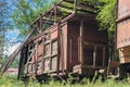 Old abandoned wooden cargo train carriage overgrown with plants Royalty Free Stock Photo